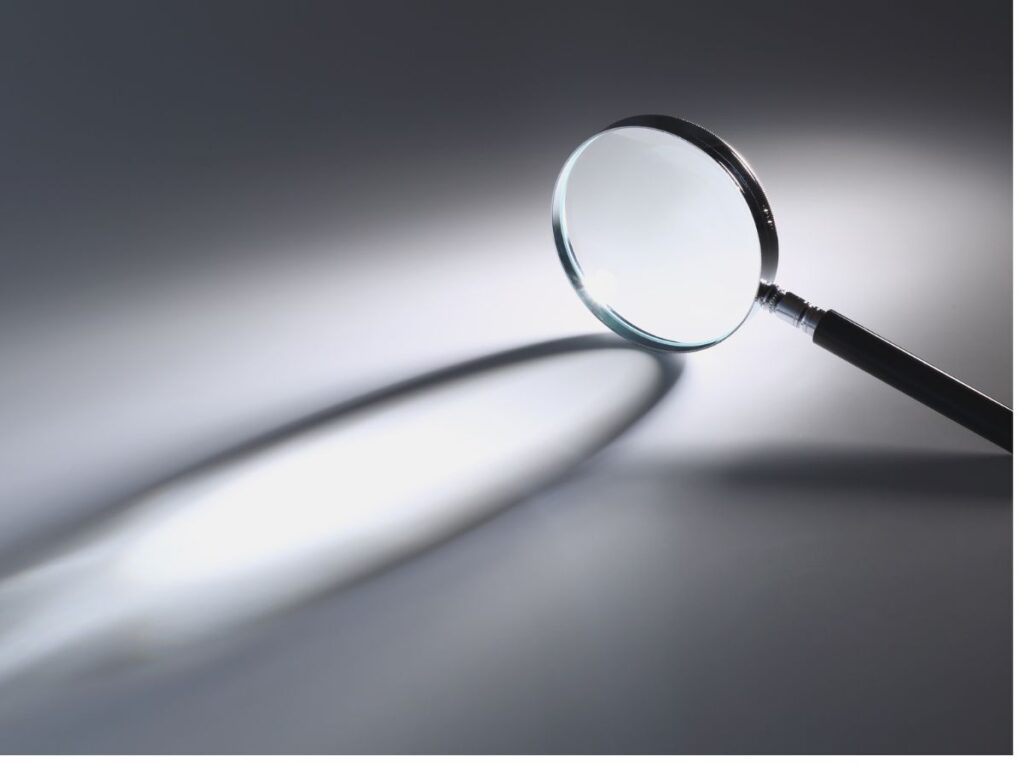 Magnifying glass casting a long shadow.
