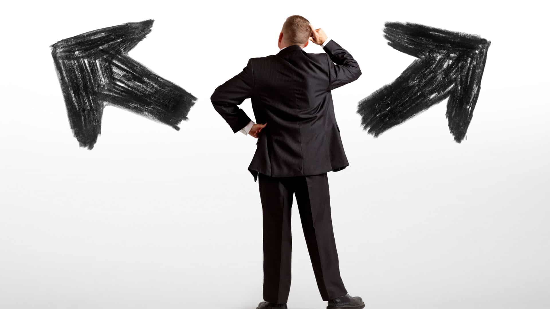 Man facing two arrows, symbolizing decision between options.