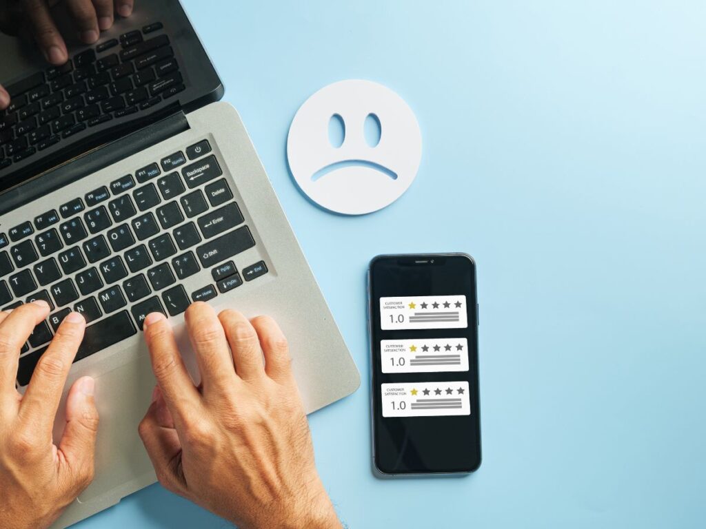 Laptop and phone showing poor customer ratings.