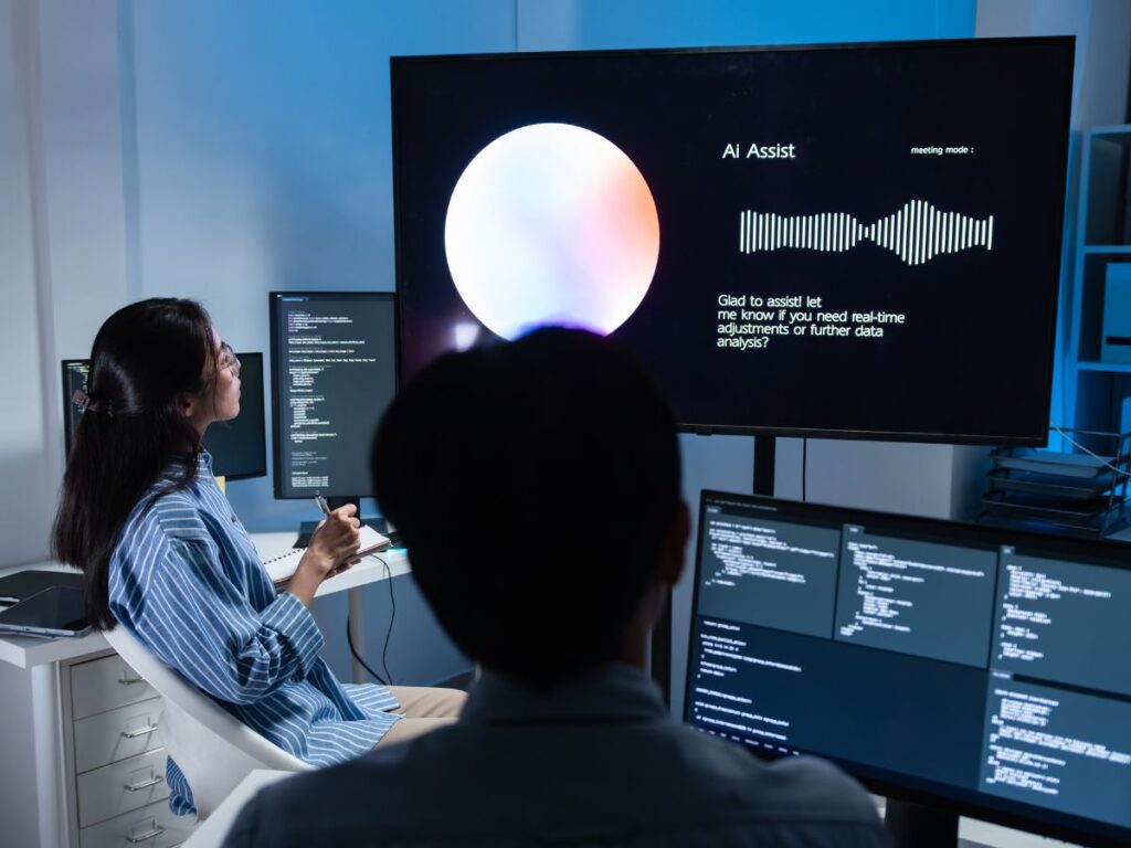 Team viewing AI assistant screen with code and analytics display.