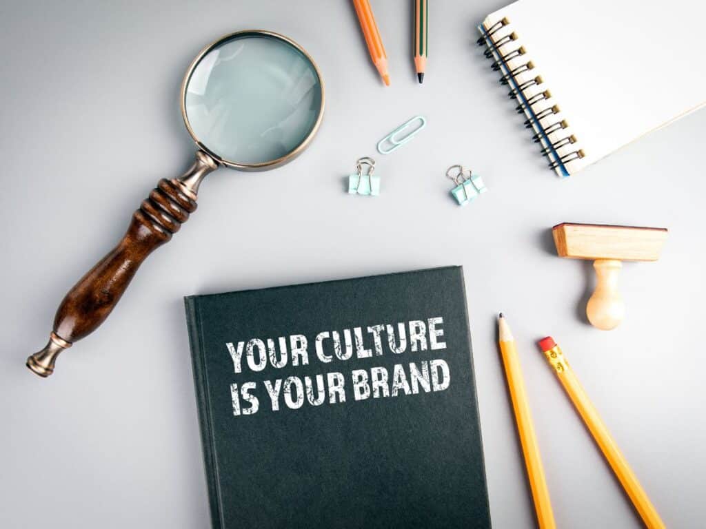 Book “Your Culture Is Your Brand” with office tools around.
