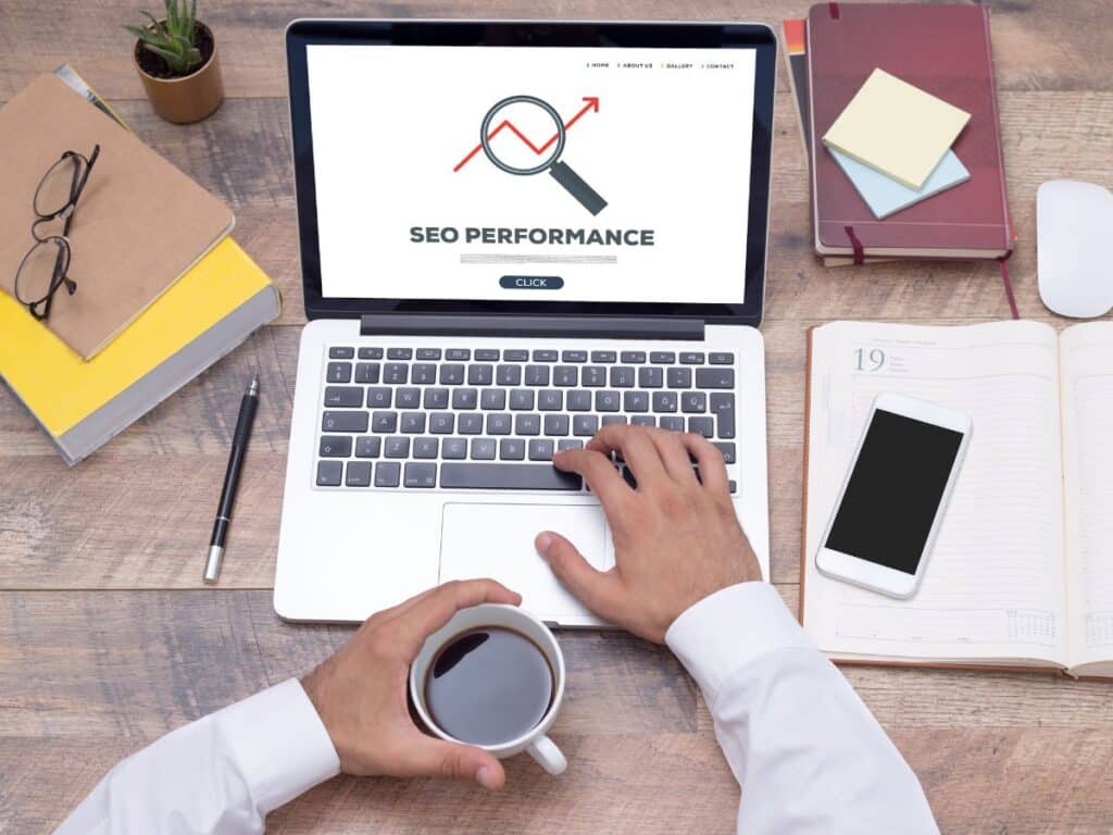 Person viewing SEO performance on a laptop at a work desk.