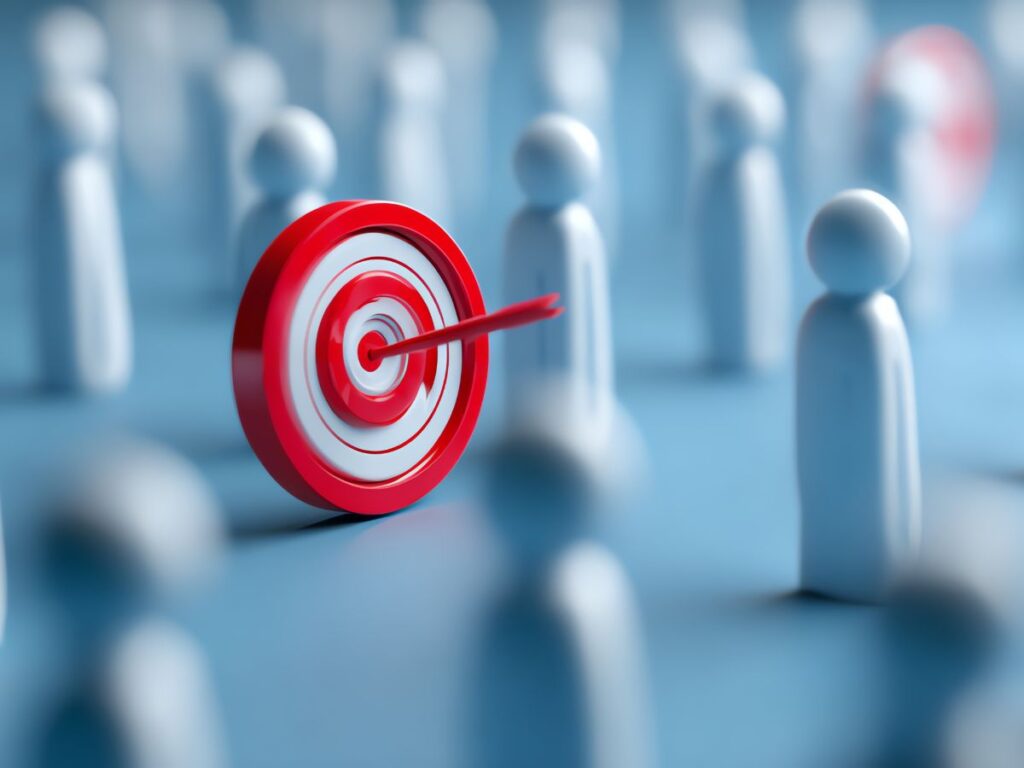 Target with arrow among figures, symbolizing audience focus.