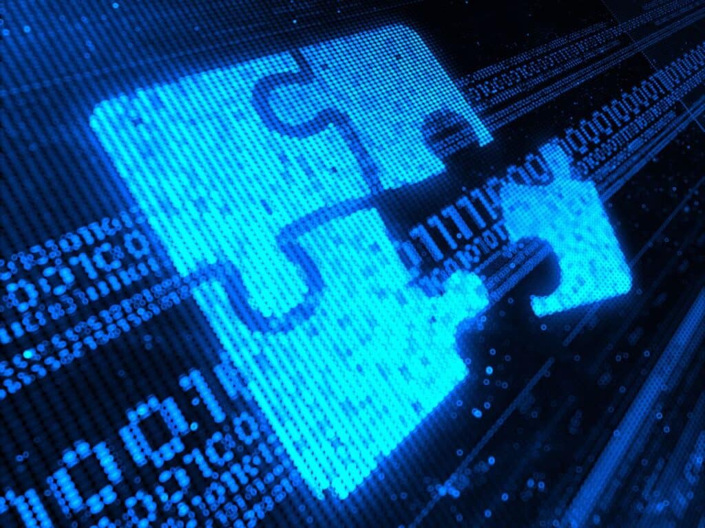 Blue digital image of puzzle pieces fitting together on a tech screen.