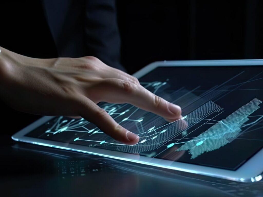 Hand using a futuristic data tablet with glowing charts.
