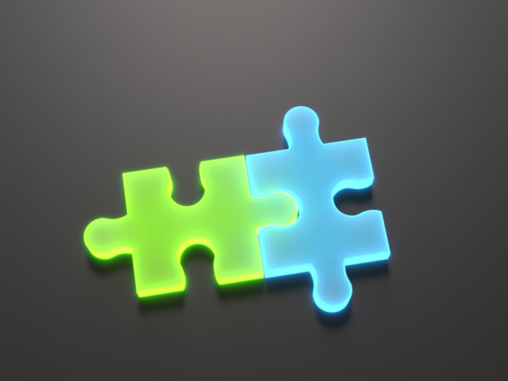 Glowing green and blue puzzle pieces linked together