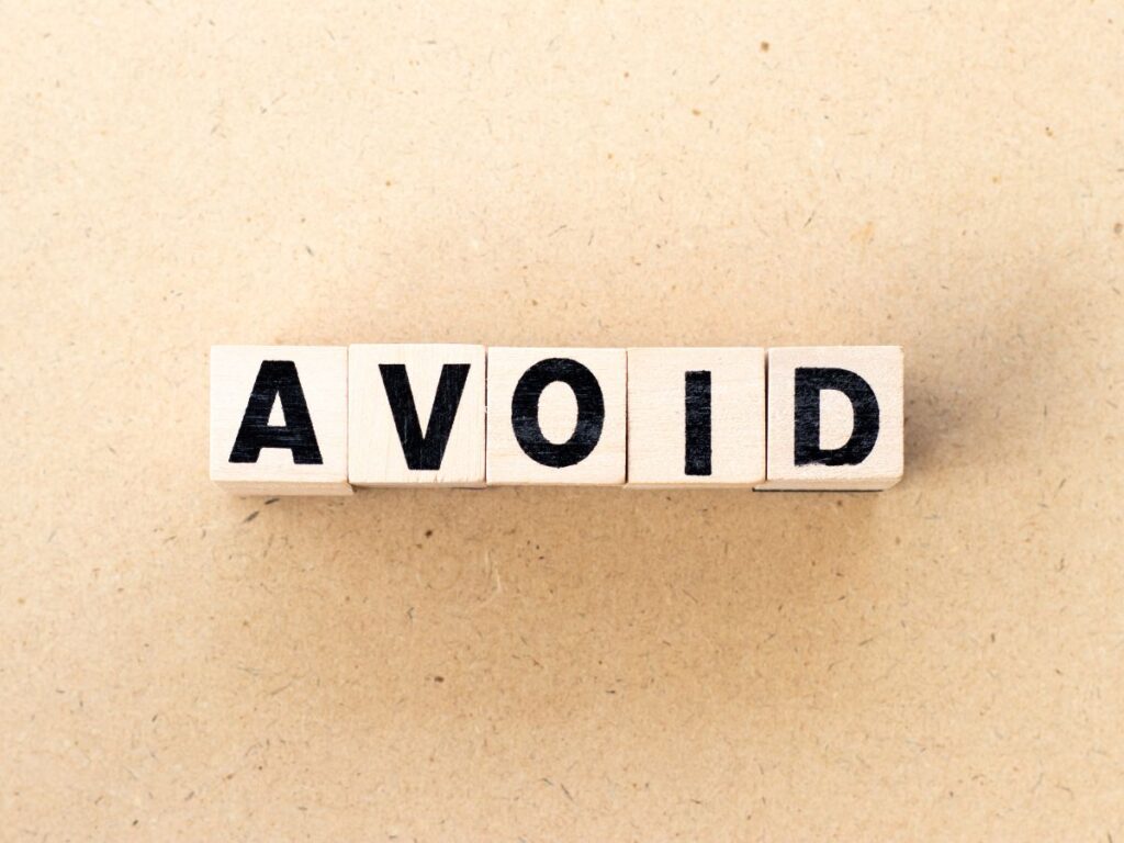 Wooden blocks spelling “AVOID”