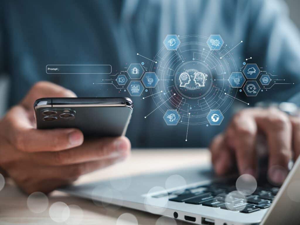 Person using a smartphone and laptop with digital mobile tech icons overlay.