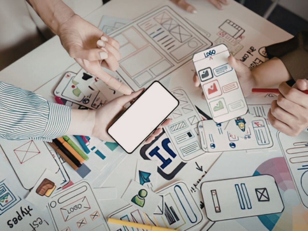 Team reviewing mobile app wireframes and prototypes.