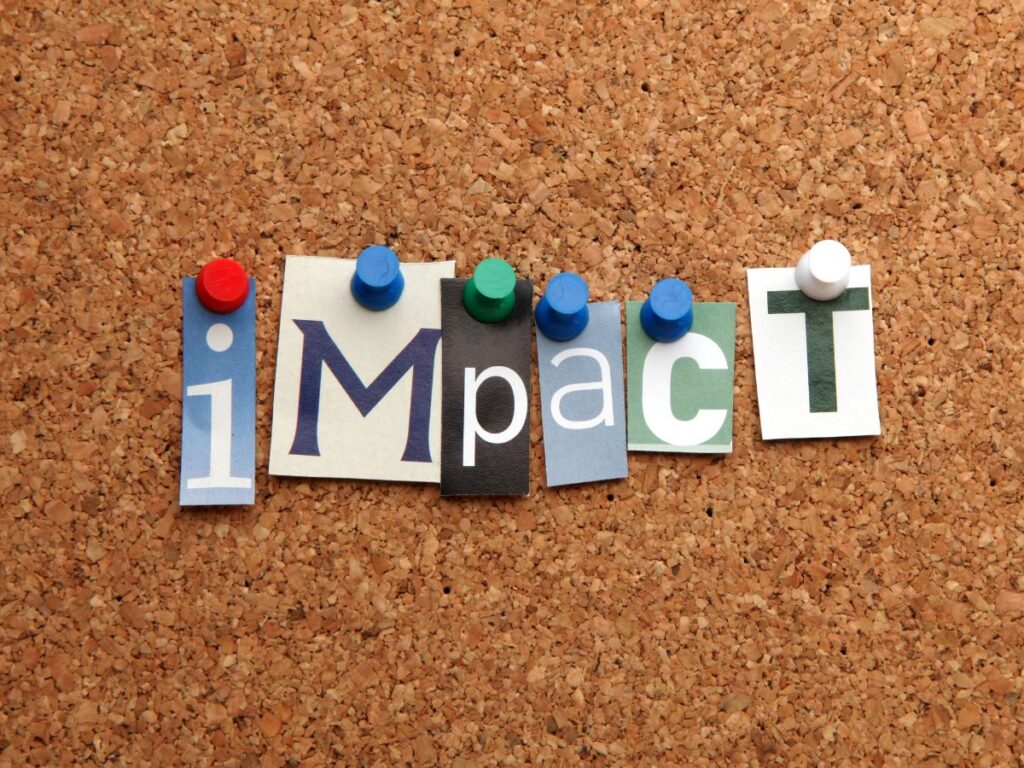 Cutout letters spelling “impact.”