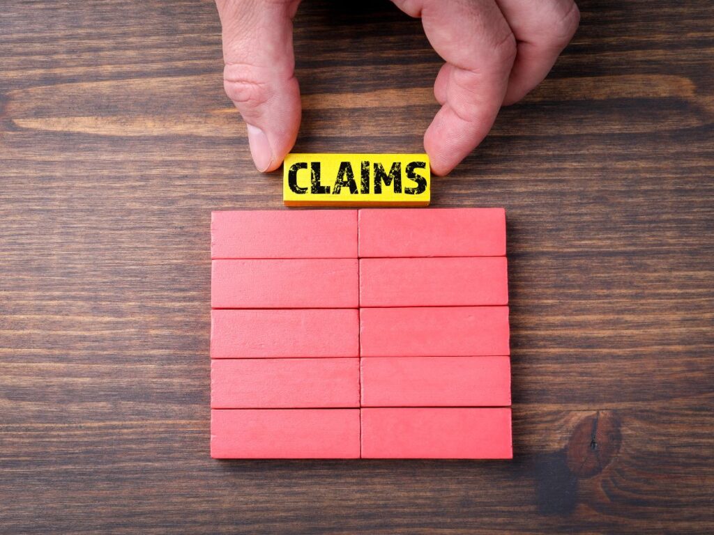 Wooden claims blocks with hand placing a label.