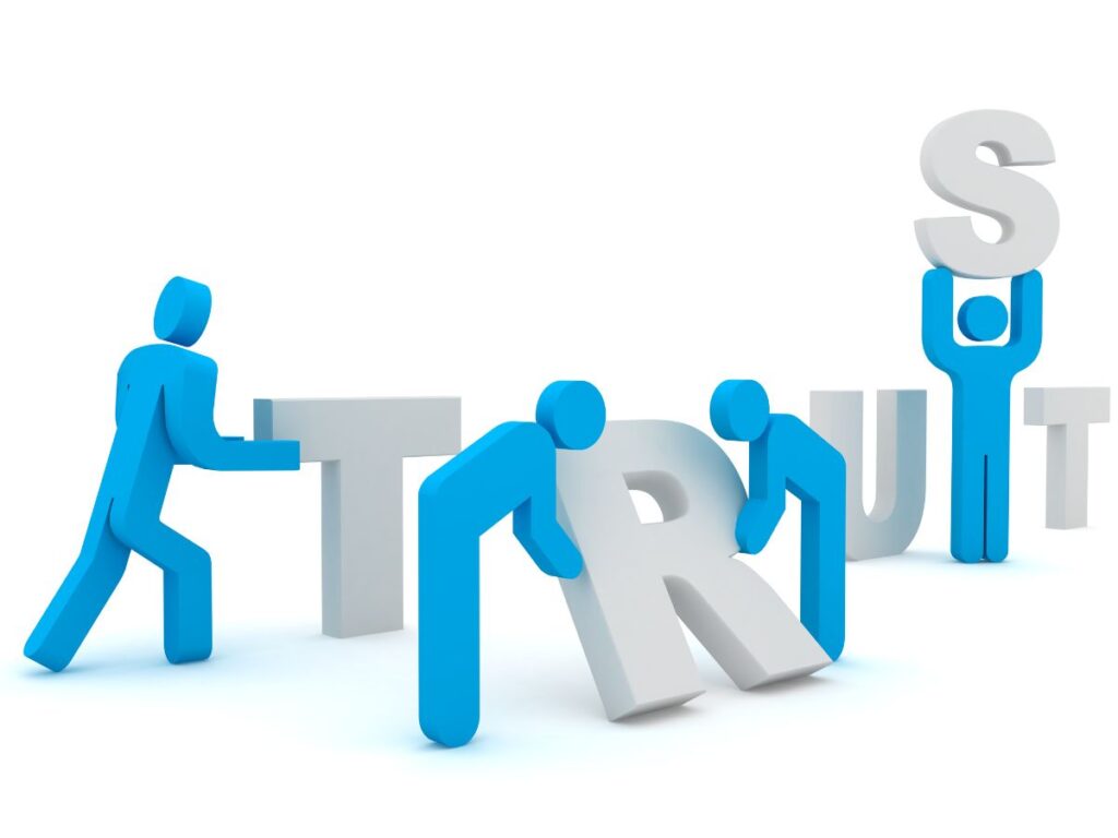 Blue figures assembling the word “TRUST.”