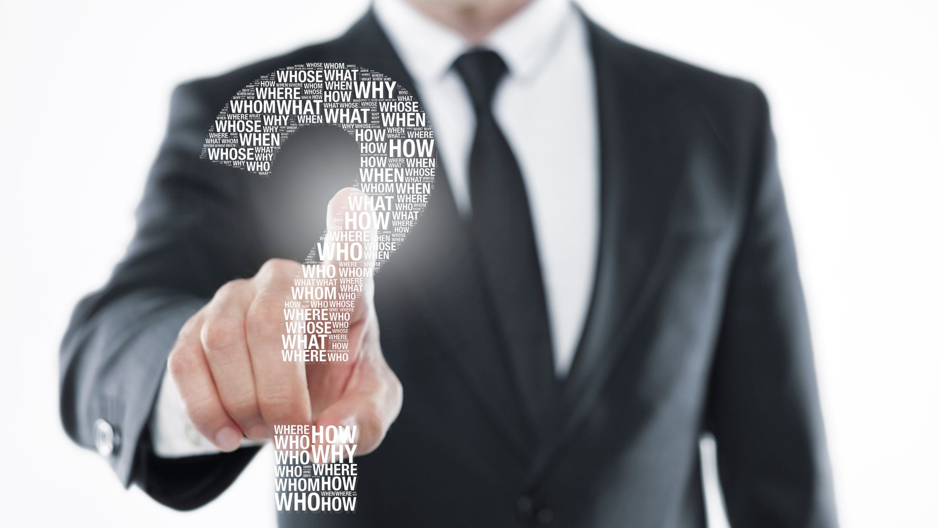 Businessman pressing a question mark graphic.