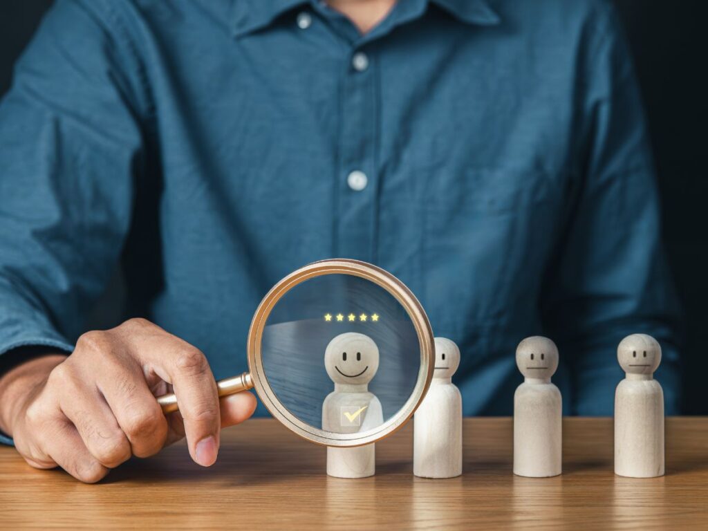 Magnifying glass highlighting a happy customer figure.