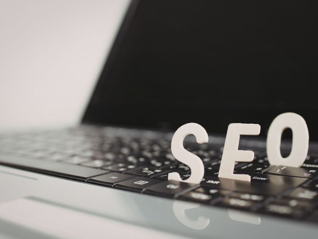 SEO letters placed on a laptop keyboard.