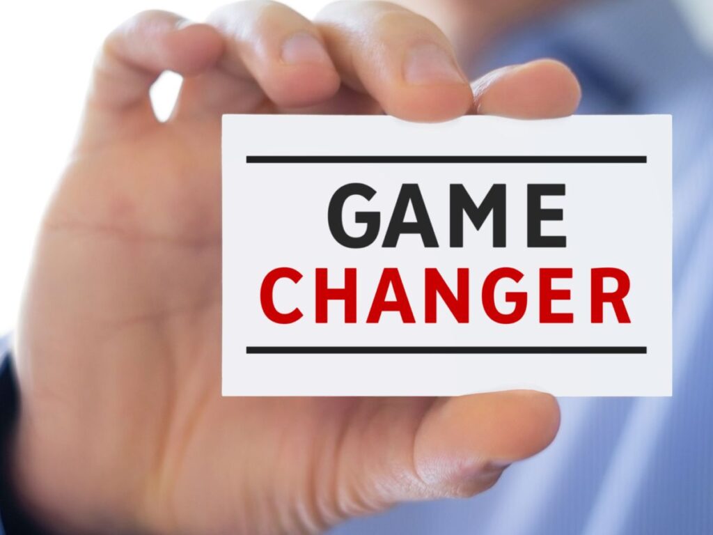 Hand holding a “Game Changer” card.