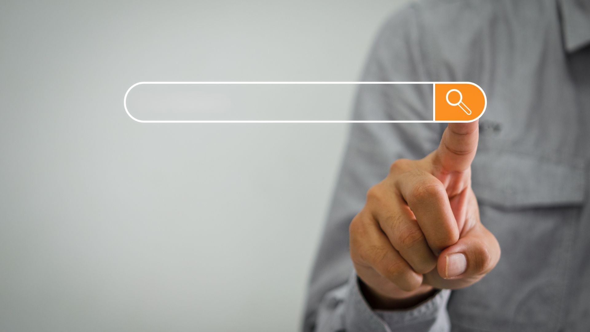 Finger pressing a digital search bar with a magnifying glass icon.