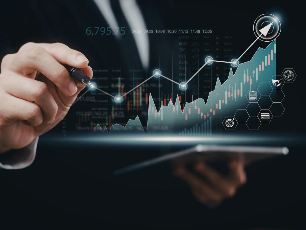 Business hand drawing an upward analytics chart