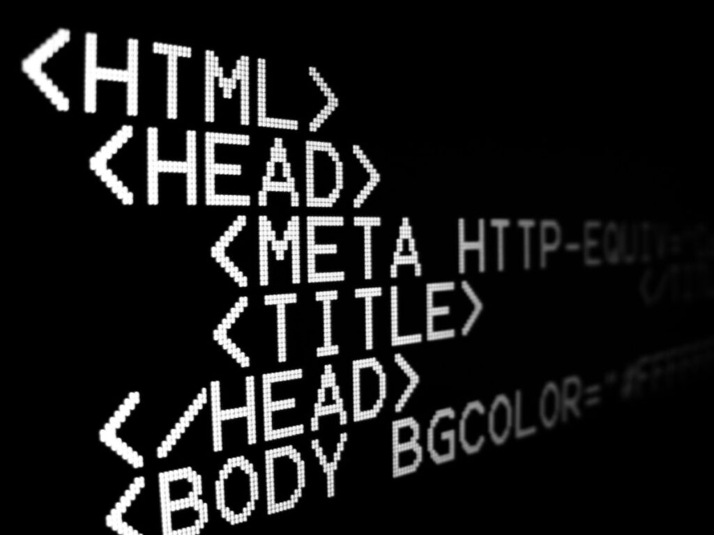 Close-up of HTML code on a dark screen