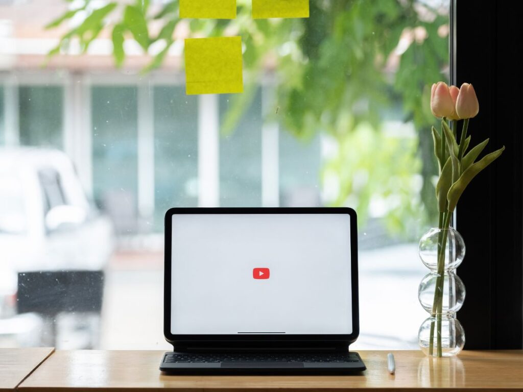Tablet showing the YouTube logo by a window